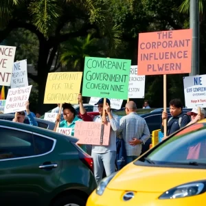 Protesters holding signs against corporate influence during Tesla protests in Jacksonville.