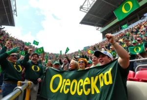 Oregon Ducks fans cheering in the stands during a college football game.