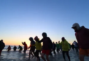 Participants preparing for the Jacksonville Beach Polar Plunge at sunrise