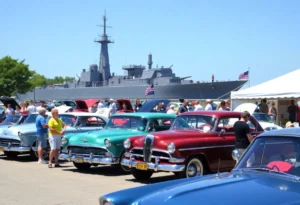Families enjoying the Pearl Harbor Remembrance Car Show with classic cars on display.