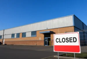 Abandoned Pella Corp installation hub with a sign of closure.