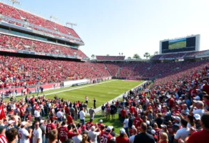 Frozen moment of the Rose Bowl game with fans showing excitement in the stands