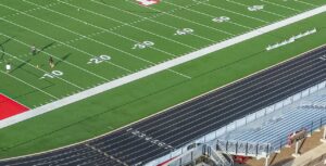 Football field yard numbers beside a running track