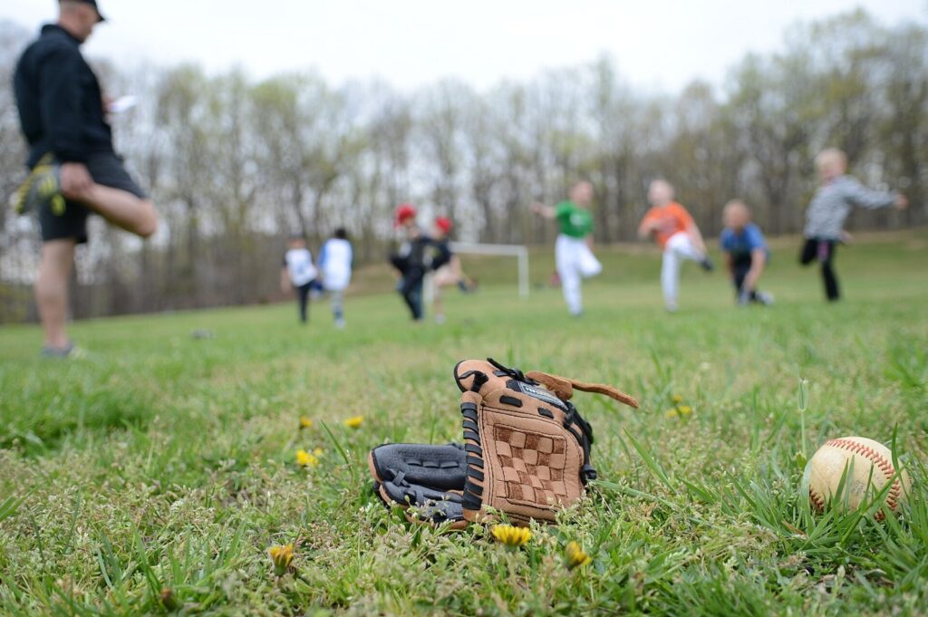 Baseball glove and ball on grass